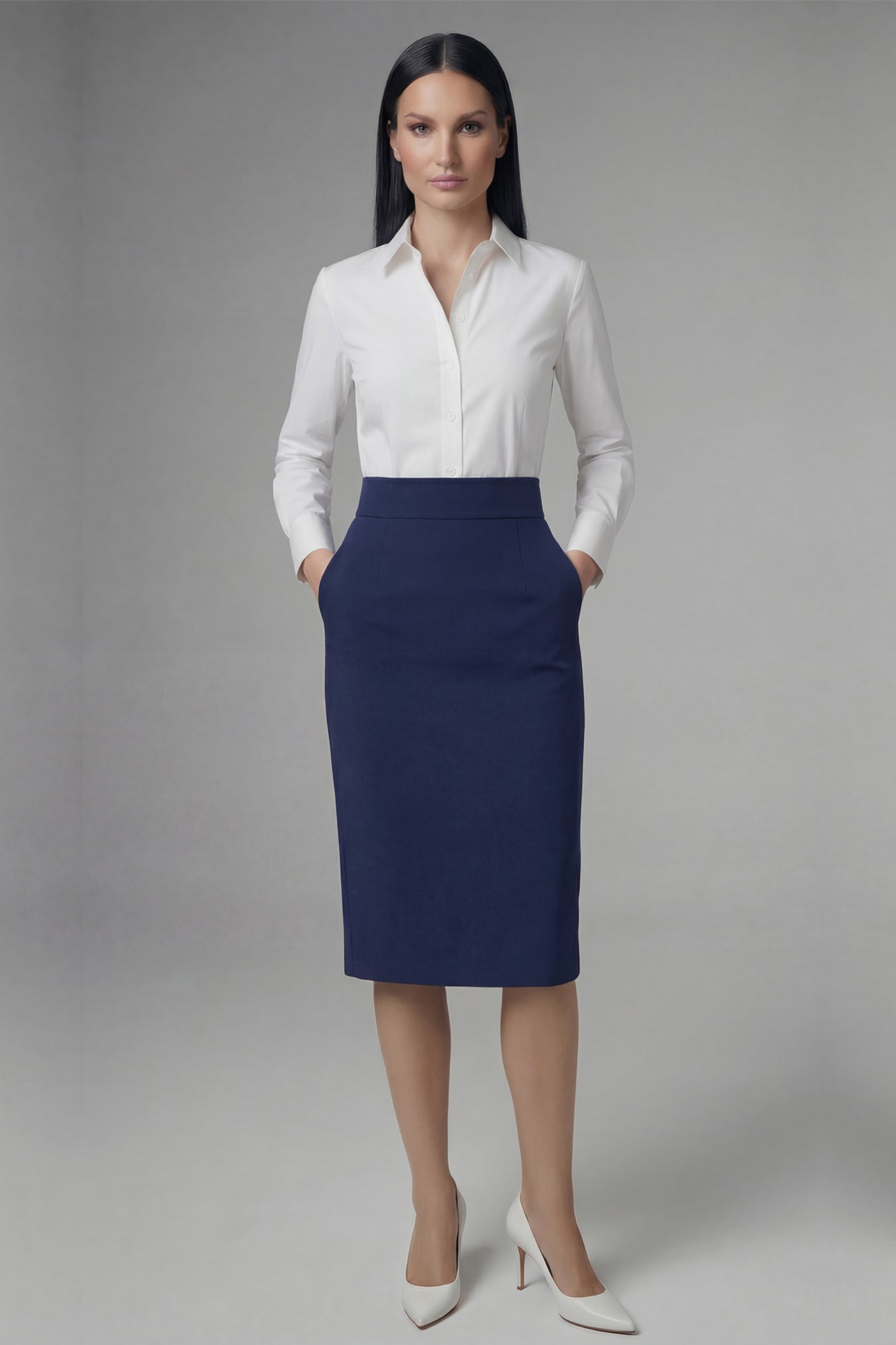 An elegant professional woman wearing a high-waisted navy blue pencil skirt featuring a slim fit, functional side pockets, and a wide waistband for a polished office look