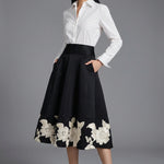 A professional woman wearing a classic crisp white long-sleeve slim-fit blouse with a sharp point collar, styled with a navy blue pencil skirt for a polished executive office look.