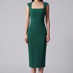 A professional woman wearing a sophisticated emerald green sleeveless dress, featuring a classic square neckline and a flattering tailored sheath silhouette for an elegant executive look.