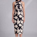 A professional woman wearing a stunning black sleeveless qipao-inspired dress, featuring a chic halter neck with a traditional mandarin collar and large elegant white floral embroidery for a modern oriental evening look.