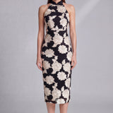 A professional woman wearing a stunning black sleeveless qipao-inspired dress, featuring a chic halter neck with a traditional mandarin collar and large elegant white floral embroidery for a modern oriental evening look.