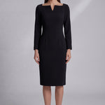 A professional woman wearing a sophisticated black long-sleeve midi dress, featuring a unique notched square neckline and a tailored slim-fit pencil silhouette for a polished executive office look.