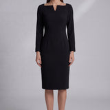 A professional woman wearing a sophisticated black long-sleeve midi dress, featuring a unique notched square neckline and a tailored slim-fit pencil silhouette for a polished executive office look.
