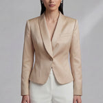 A professional woman wearing an elegant champagne-colored satin blazer with a sophisticated shawl collar and tailored waist, styled for a luxury business or evening event.