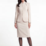 A professional woman wearing a sophisticated beige modern Qipao-inspired skirt suit, featuring a tailored blazer with traditional Chinese frog buttons and a stand collar for an elegant executive office look.