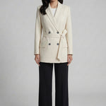 A professional woman wearing a sophisticated cream pinstripe blazer, featuring a double-breasted front with a chic waist-tie belt and notched lapels for a polished old money office look.