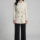 A professional woman wearing a sophisticated cream pinstripe blazer, featuring a double-breasted front with a chic waist-tie belt and notched lapels for a polished old money office look.