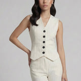 A professional woman wearing a sophisticated off-white pinstripe vest top, featuring a slim-fit tailored silhouette, classic V-neck, and contrasting black buttons for a modern business casual look.