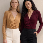 A style comparison of two elegant long-sleeve V-neck wrap tops featuring delicate shoulder pleating and a sleek tucked-in fit; the left in warm camel paired with cream trousers, and the right in deep burgundy paired with black trousers.