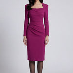 A professional woman wearing a sophisticated deep magenta long-sleeve pencil dress, featuring a unique square neckline and elegant ruched detailing at the waist for a flattering, slim-fit executive look.