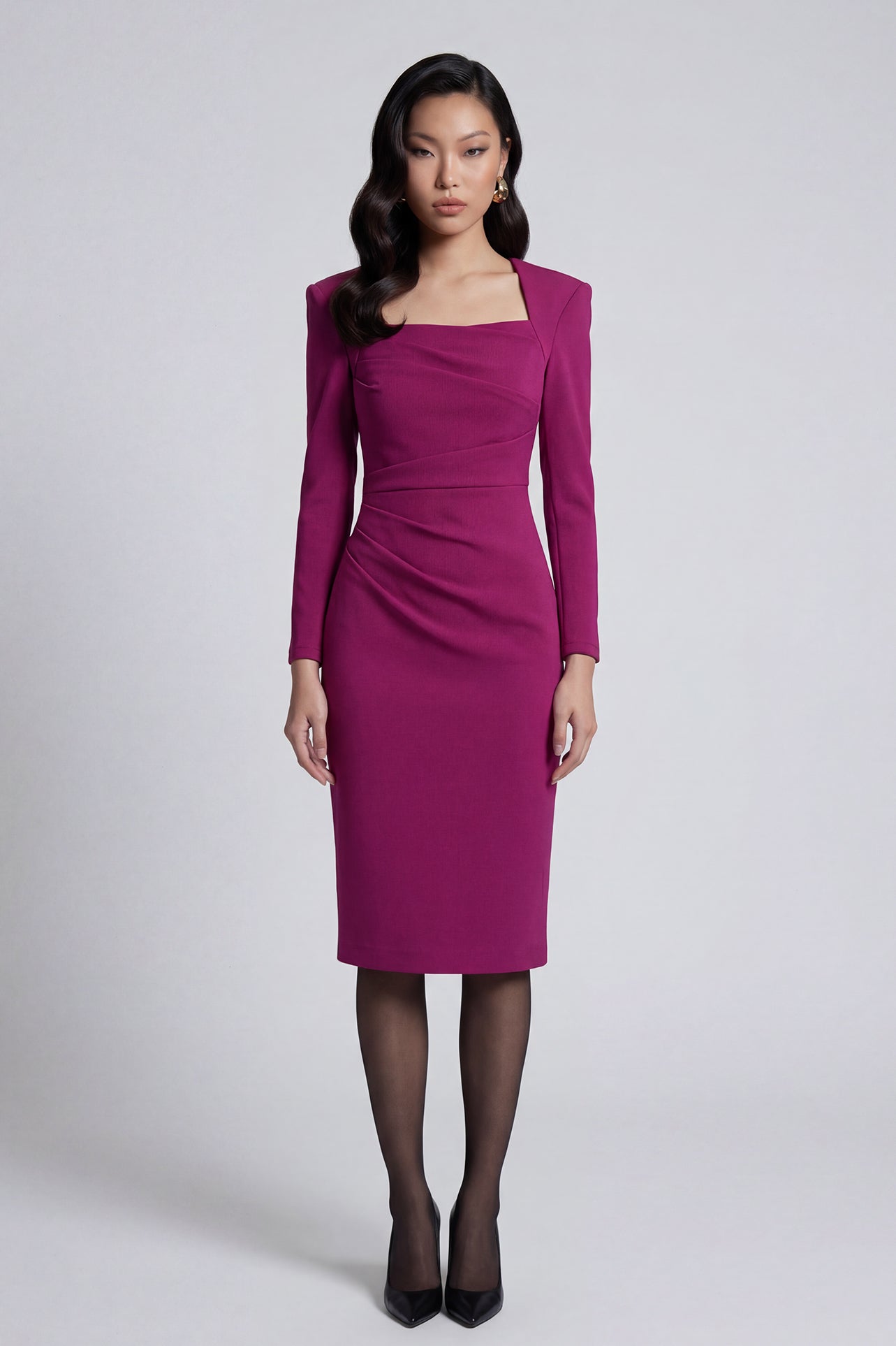 A professional woman wearing a sophisticated deep magenta long-sleeve pencil dress, featuring a unique square neckline and elegant ruched detailing at the waist for a flattering, slim-fit executive look.