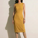 A professional woman modeling an elegant mustard yellow sleeveless sheath dress, featuring a sophisticated crew neckline and a tailored slim fit with princess seams for a polished executive look.