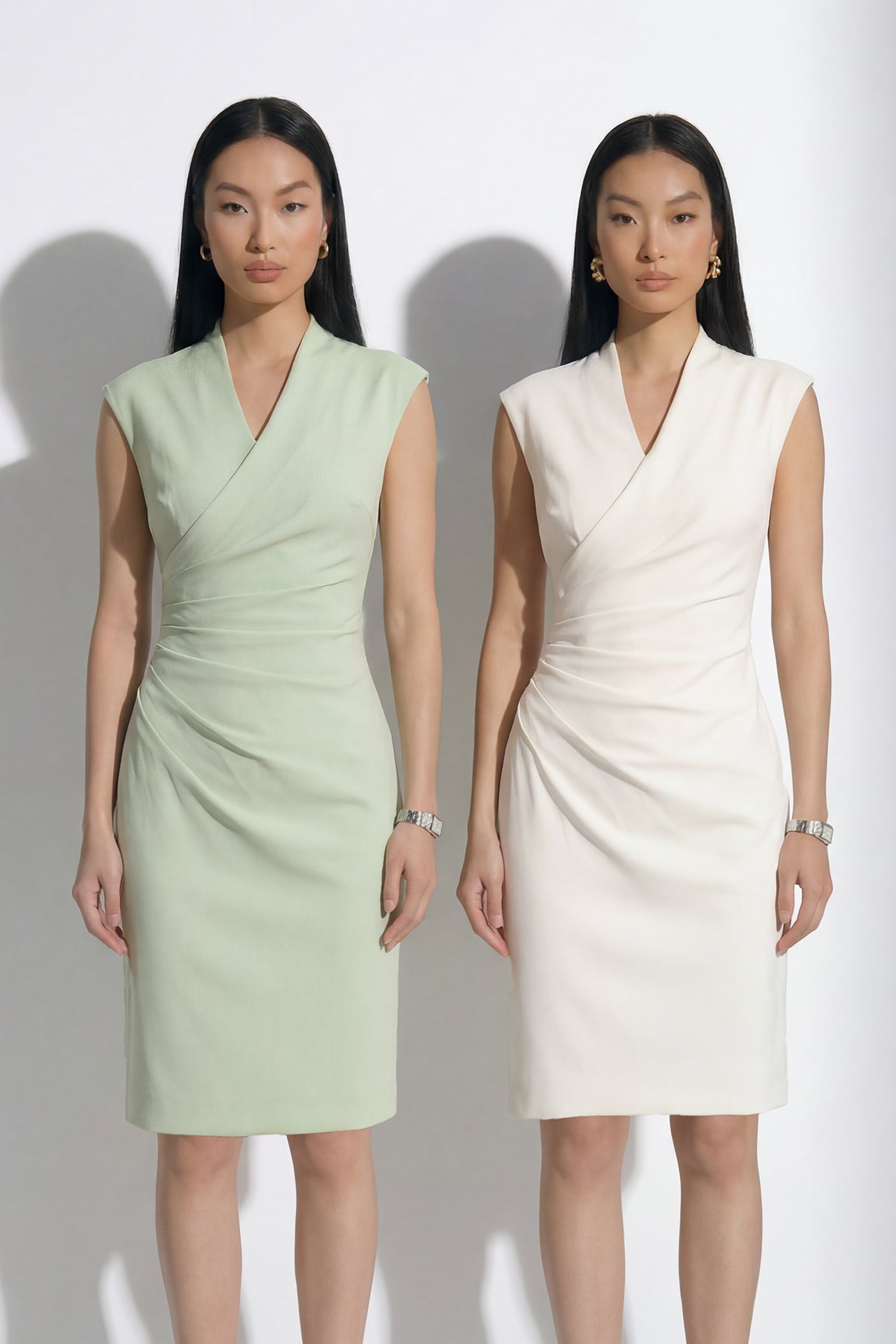 A professional woman modeling an elegant navy blue double-breasted trench dress, featuring a sophisticated notched lapel, a structured belt, and a pleated A-line skirt for a polished executive office look.