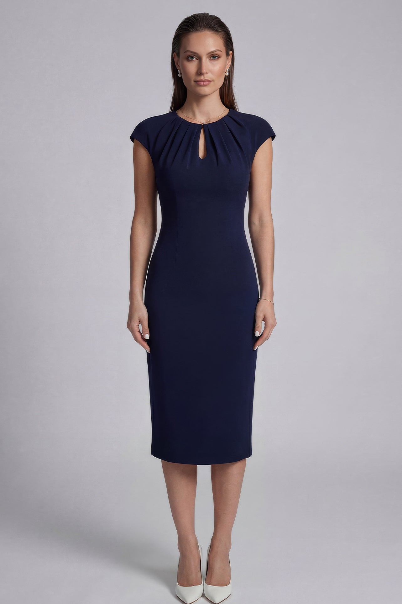 A professional woman wearing a sophisticated navy blue midi dress, featuring an elegant pleated neckline with a subtle keyhole detail and a tailored slim-fit pencil silhouette for a polished executive look.