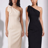 A style comparison of two elegant one-shoulder midi dresses; the left showcasing a sophisticated beige tailored sheath dress with a large tie-bow shoulder strap, and the right featuring the same design in timeless minimalist black.