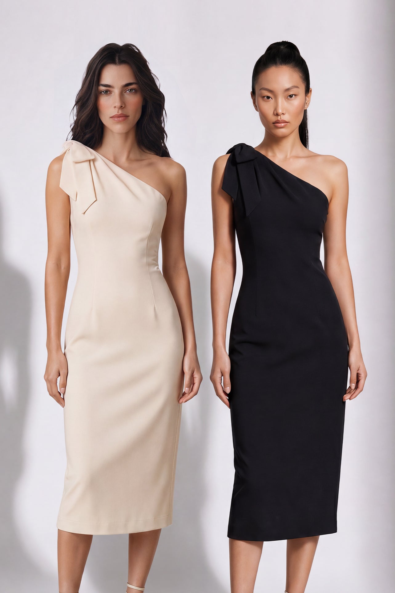 A style comparison of two elegant one-shoulder midi dresses; the left showcasing a sophisticated beige tailored sheath dress with a large tie-bow shoulder strap, and the right featuring the same design in timeless minimalist black.