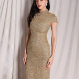 A professional woman wearing a stunning luxurious gold sequined modern qipao dress, featuring a traditional mandarin collar, short cap sleeves, and a slim-fit floor-length silhouette for a formal evening gala.