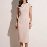 A professional woman modeling an elegant pale pink sheath dress, featuring a sophisticated crew neckline, cap sleeves, and a tailored slim fit with princess seams for a timeless executive look.
