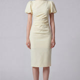 A professional woman wearing a sophisticated pale yellow short-sleeve midi dress, featuring elegant puff sleeves and a slimming ruched waistline for a polished and fresh summer office look.