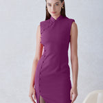 A professional woman wearing a stunning magenta purple sleeveless dress, featuring a traditional mandarin collar, a row of elegant side buttons, and a sophisticated high slit for a modern oriental look.