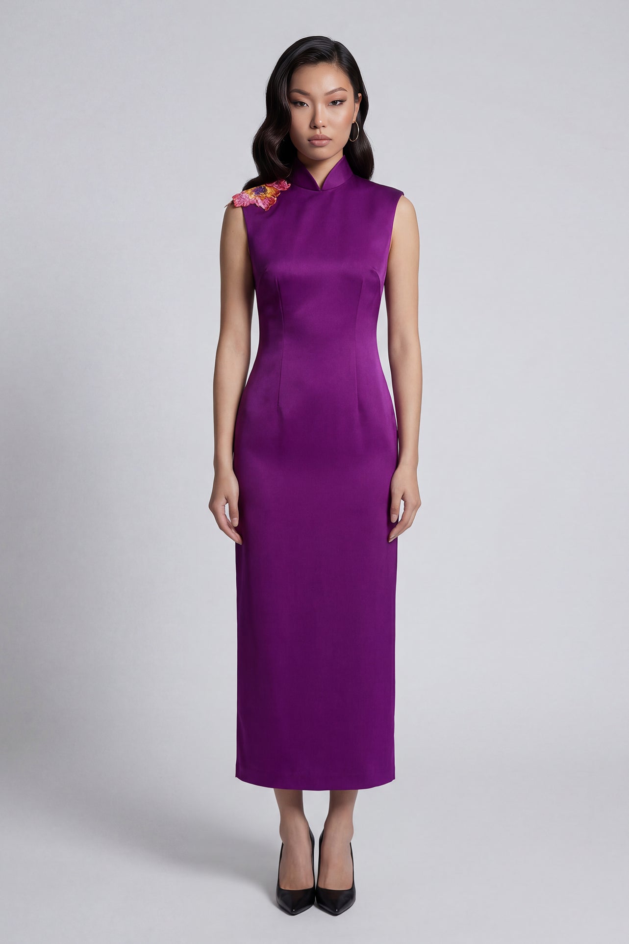 A professional woman wearing a stunning purple satin sleeveless dress, featuring a traditional mandarin collar and delicate floral embroidery on the shoulder for a modern oriental-inspired formal look.