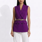 A professional woman modeling an elegant deep purple sleeveless double-breasted blazer vest, featuring a notched lapel, front flap pockets, and a slim belt, paired with white tailored trousers for a sophisticated office look.