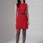 A professional woman wearing a sophisticated vibrant red tweed sleeveless mini dress, featuring a classic round neck, elegant frayed edges, and a slimming black waist belt for a chic holiday or office look.