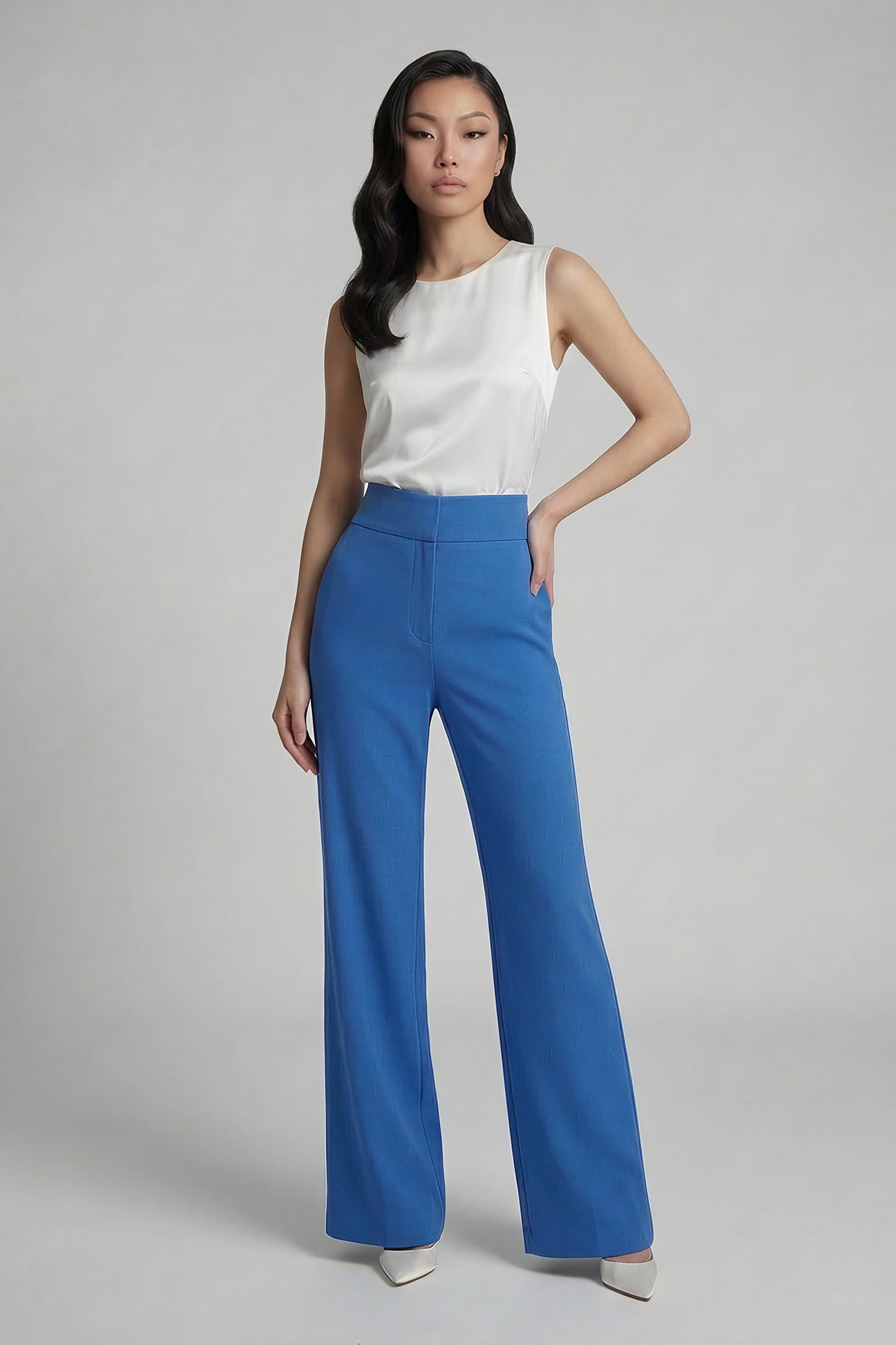 A professional woman wearing sophisticated royal blue high-waisted wide-leg trousers, featuring a tailored loose-fit silhouette for a modern and vibrant executive office look.