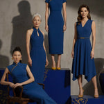 A collection of four professional models of different ages wearing elegant royal blue dresses featuring modern Chinese elements, including mandarin collars, traditional knot buttons, and diverse silhouettes from sleek sheaths to pleated A-line skirts.