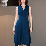 A professional woman modeling an elegant royal blue sleeveless V-neck dress, featuring a tailored fit-and-flare silhouette and a flowing midi A-line skirt for a sophisticated office or social look.