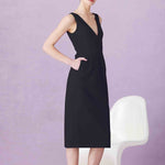 A professional woman showcasing two elegant sleeveless V-neck sheath dresses in classic black and soft lilac purple, featuring functional side pockets and a tailored fit for a polished office look.