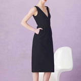 A professional woman showcasing two elegant sleeveless V-neck sheath dresses in classic black and soft lilac purple, featuring functional side pockets and a tailored fit for a polished office look.
