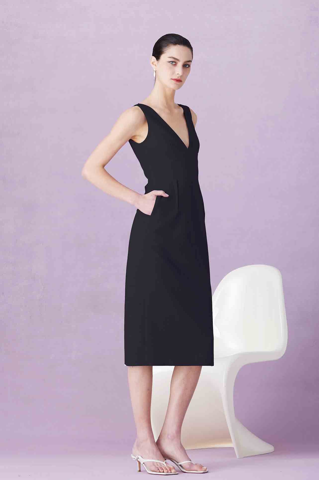 A professional woman showcasing two elegant sleeveless V-neck sheath dresses in classic black and soft lilac purple, featuring functional side pockets and a tailored fit for a polished office look.