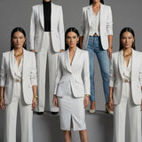 Two professional women showcasing high-end executive business suits: one in a crisp white pant suit with a shawl lapel blazers, and the other in a sophisticated camel skirt suit with a tailored vest, perfect for formal corporate settings.