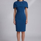 A professional woman wearing a sophisticated teal blue midi dress with an elegant cape-style overlay and structured shoulders, perfect for formal executive events and ceremonial occasions.