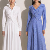 A style comparison of two elegant long-sleeve shirt maxi dresses featuring a unique twist knot waist design; the left showcasing a minimalist solid white dress with a popped collar, and the right featuring a classic blue and white vertical striped dress with a flattering A-line flare skirt.