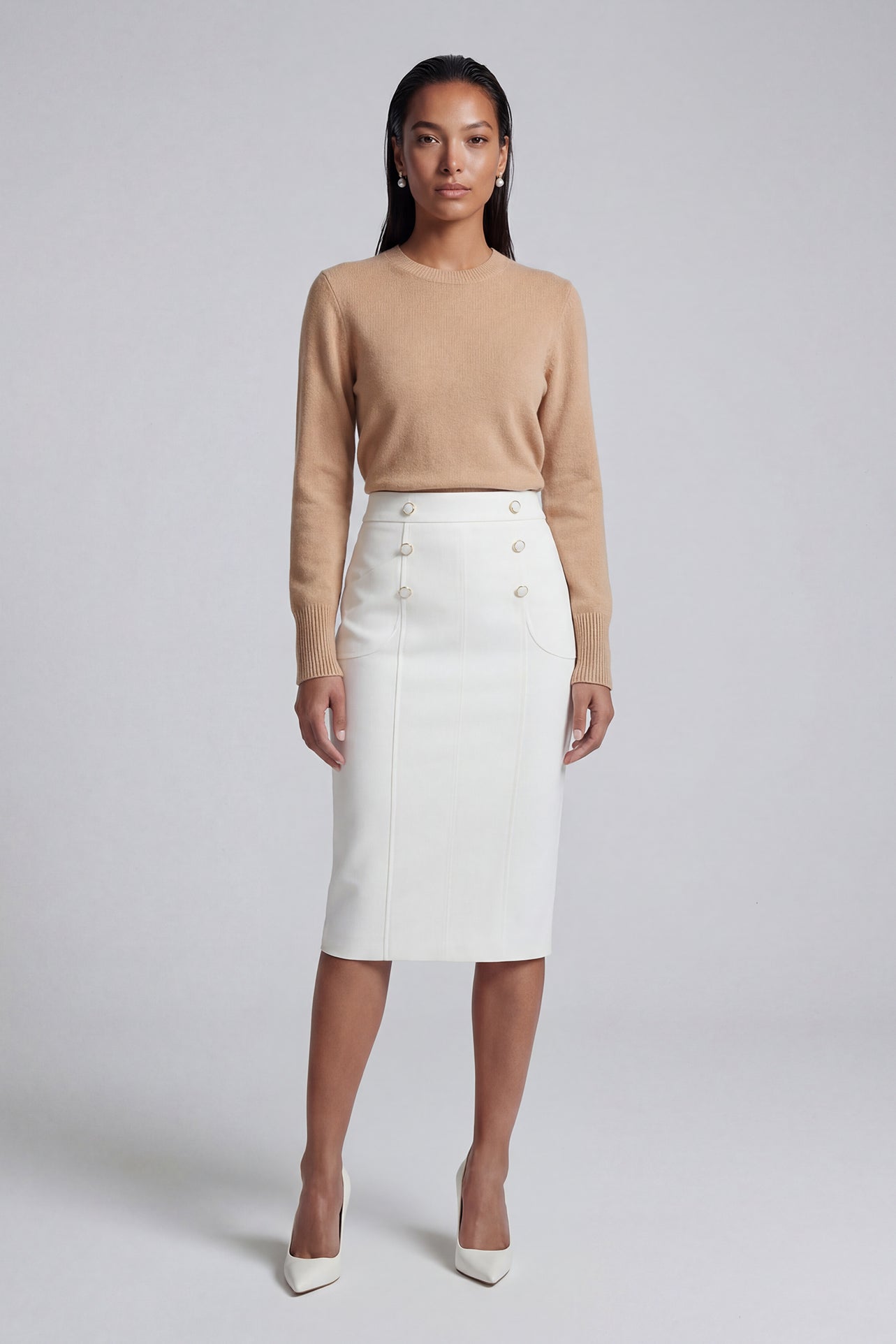 A professional woman wearing a sophisticated high-waisted white pencil skirt featuring elegant double-breasted button decorations and a slimming tailored fit, ideal for corporate business wear.