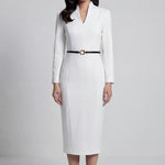 A professional woman wearing a sophisticated solid white long-sleeve sheath dress, featuring an elegant V-neckline and a slim black belt with a gold buckle for a polished executive office look.