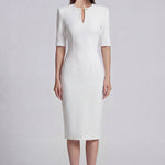 A sophisticated professional woman wearing a tailored black longline blazer with a belted waist and gold buckle, featuring a slimming executive silhouette for a formal office look.