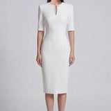 A sophisticated professional woman wearing a tailored black longline blazer with a belted waist and gold buckle, featuring a slimming executive silhouette for a formal office look.