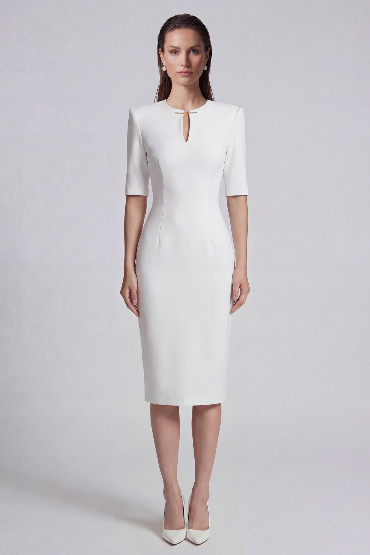 A sophisticated professional woman wearing a tailored black longline blazer with a belted waist and gold buckle, featuring a slimming executive silhouette for a formal office look.