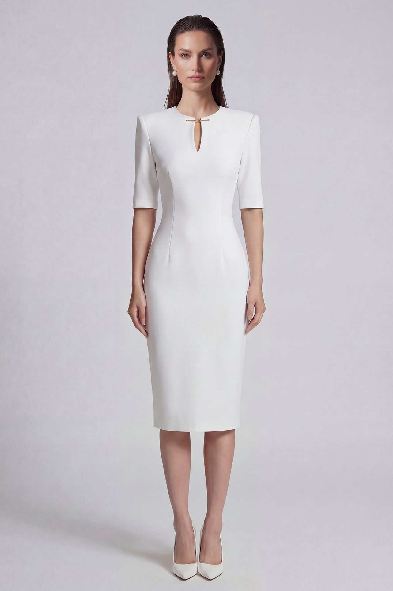 A sophisticated professional woman wearing a tailored black longline blazer with a belted waist and gold buckle, featuring a slimming executive silhouette for a formal office look.