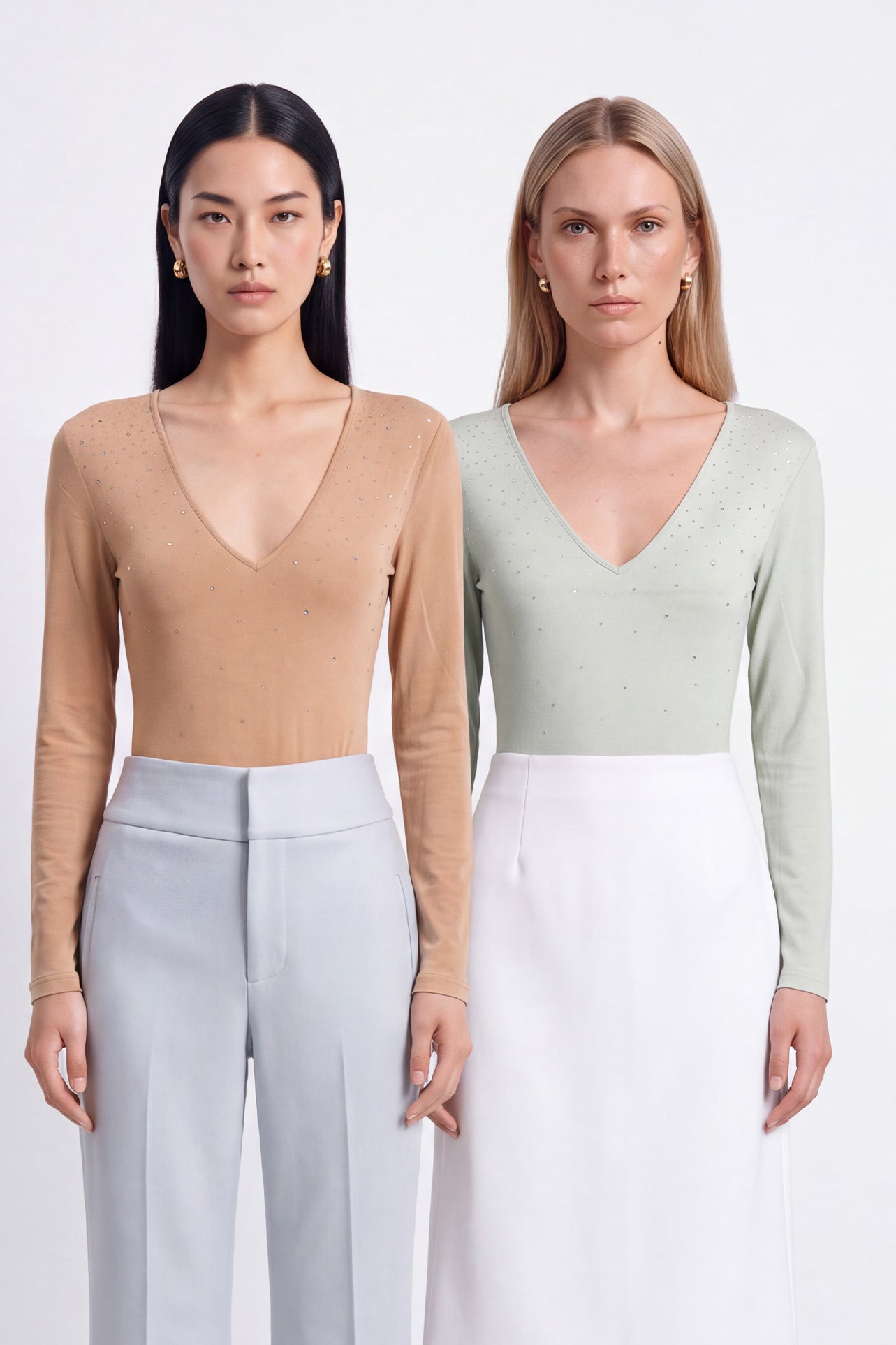 A style comparison of two elegant women's long-sleeve deep V-neck tops featuring subtle rhinestone crystal embellishments; shown on the left in nude camel tucked into tailored trousers, and on the right in pale mint green styled with a white skirt.