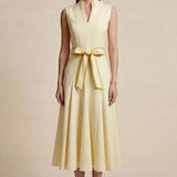 A side-by-side comparison of an elegant pale yellow sleeveless dress in two lengths, featuring a sophisticated mandarin collar, a stylish bow tie-waist, and a pleated A-line skirt for a classic feminine look