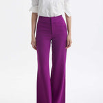 A professional woman wearing a classic crisp white long-sleeve slim-fit blouse with a sharp point collar, styled with a navy blue pencil skirt for a polished executive office look.