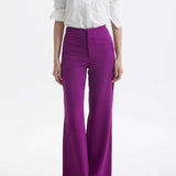 A professional woman wearing a classic crisp white long-sleeve slim-fit blouse with a sharp point collar, styled with a navy blue pencil skirt for a polished executive office look.