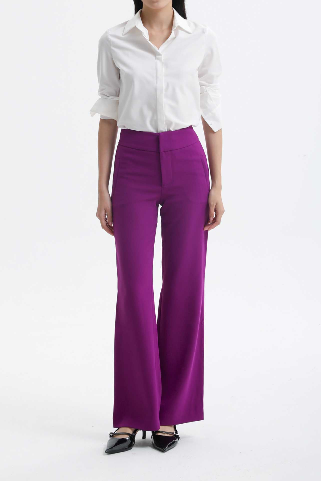 A professional woman wearing a classic crisp white long-sleeve slim-fit blouse with a sharp point collar, styled with a navy blue pencil skirt for a polished executive office look.