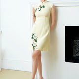 A professional woman wearing a stunning lemon yellow sleeveless mini dress, featuring a traditional mandarin collar, exquisite white floral 3D embroidery, and an elegant side slit for a sophisticated modern oriental look.