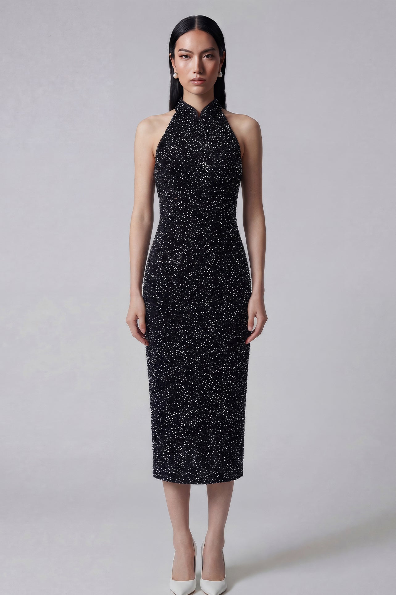 A stunning woman wearing a sophisticated black sequin halter midi dress, featuring a traditional mandarin collar and a shimmering bodycon silhouette, perfect for a modern oriental-inspired evening party look.