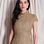 A professional woman wearing a stunning luxurious gold sequined modern qipao dress, featuring a traditional mandarin collar, short cap sleeves, and a slim-fit floor-length silhouette for a formal evening gala.